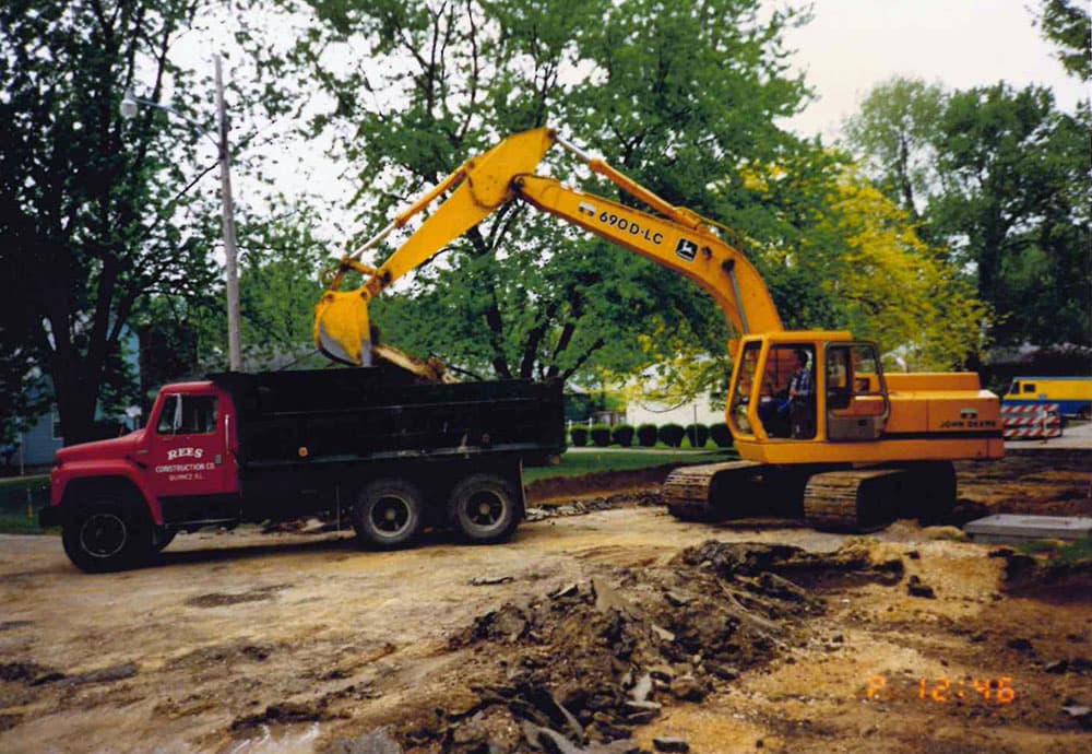 historic photo of digger loading dump truck